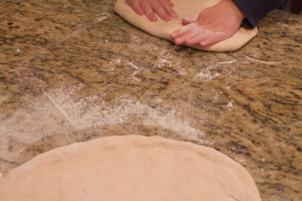 stretching pizza dough by hand