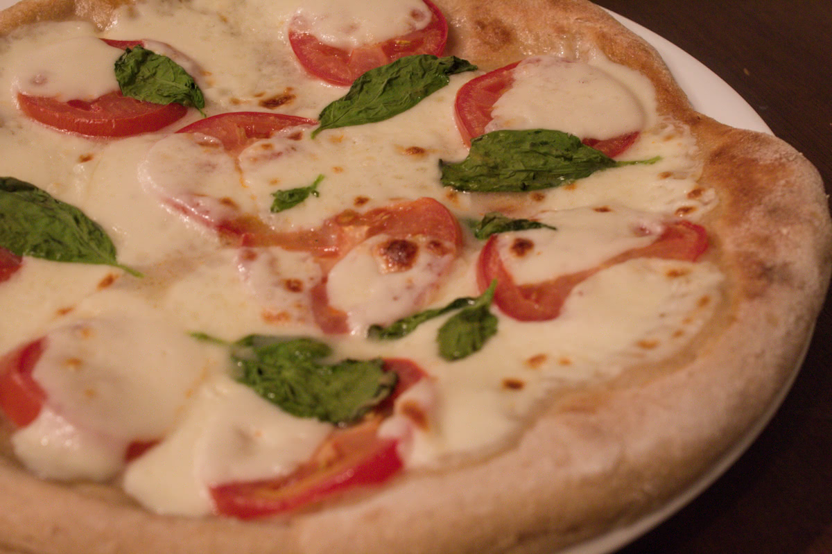 Tomato Basil pizza with a whole wheat sourdough crust.