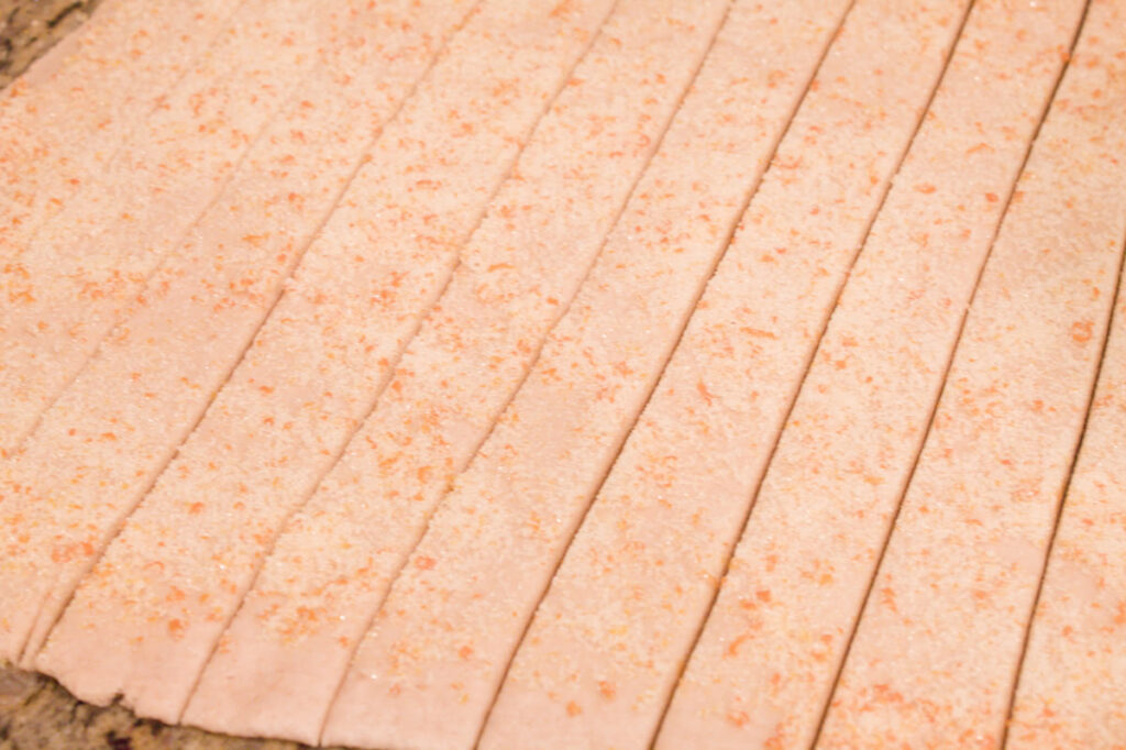 Strips of roll dough topped with orange zest and sugar. 